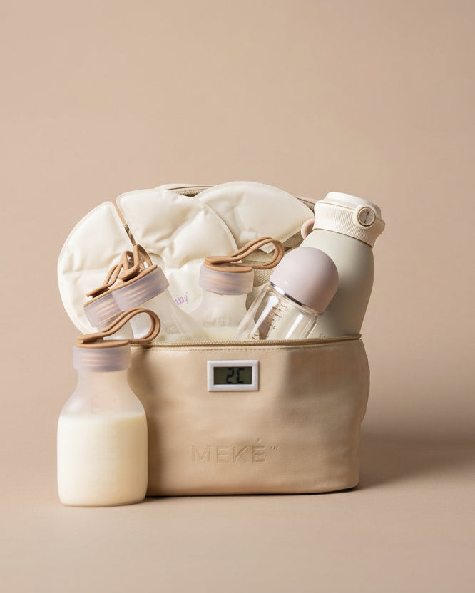 A beige fabric chiller bag filled with baby bottles, a bottle warmer, and a milk warmer, set against a solid beige background. The brand name 'MEKE' is visible on the packaging.