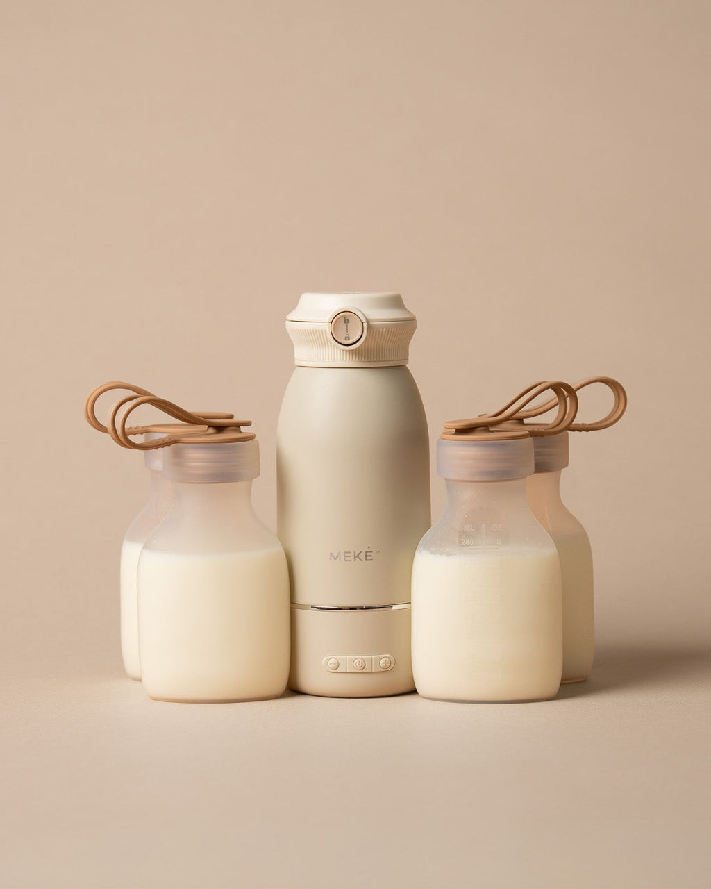A set of minimalist matte clear coloured silicone pouches and milk warmer
