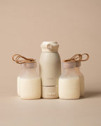 A set of minimalist matte clear coloured silicone pouches and milk warmer