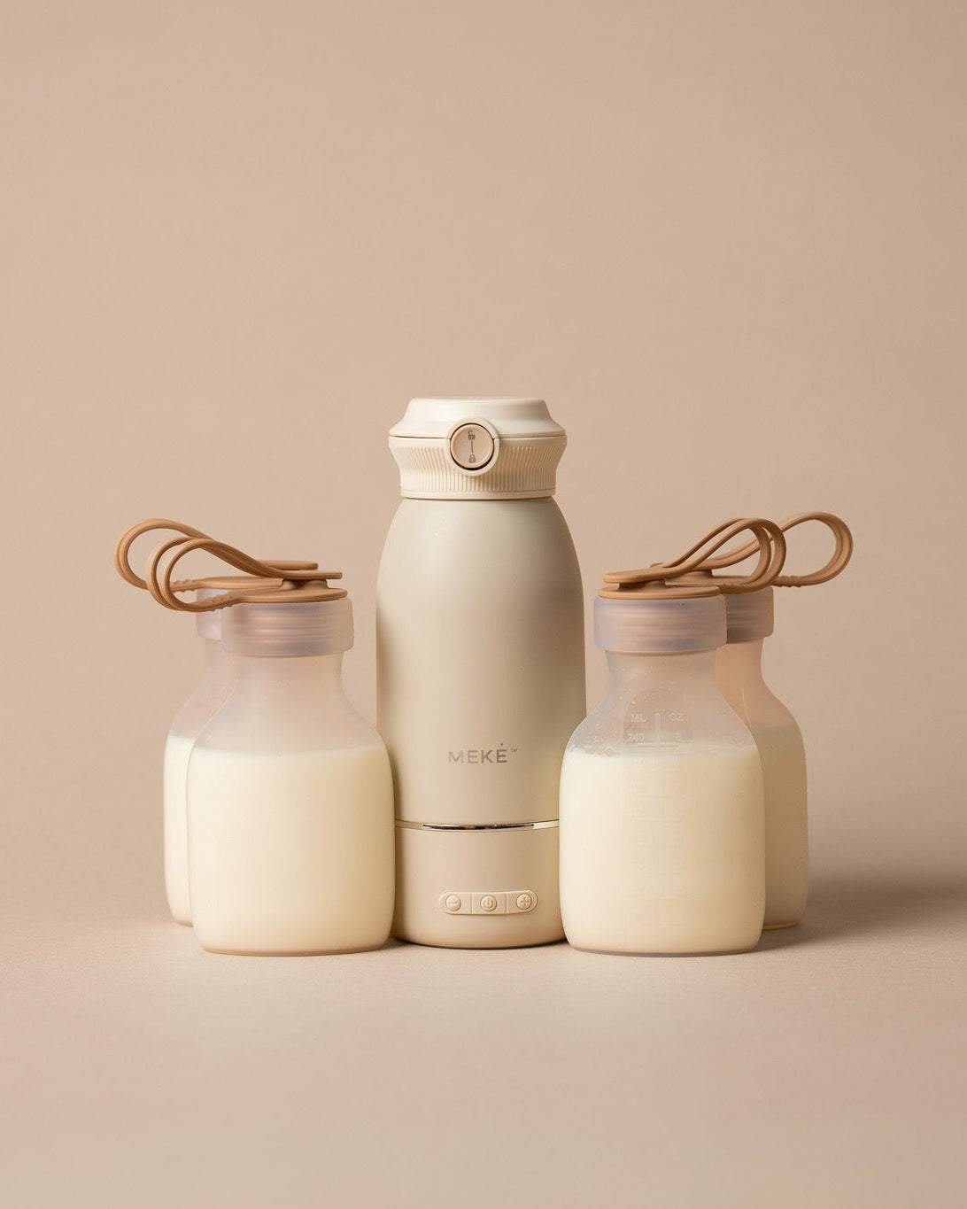 A set of minimalist matte clear coloured silicone pouches and milk warmer